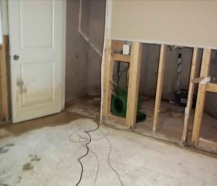Basement room with the lower half of the wall having been cut out following a flood