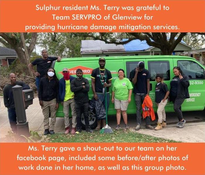 Crew members standing in front of a green SERVPRO van with satisfied customer