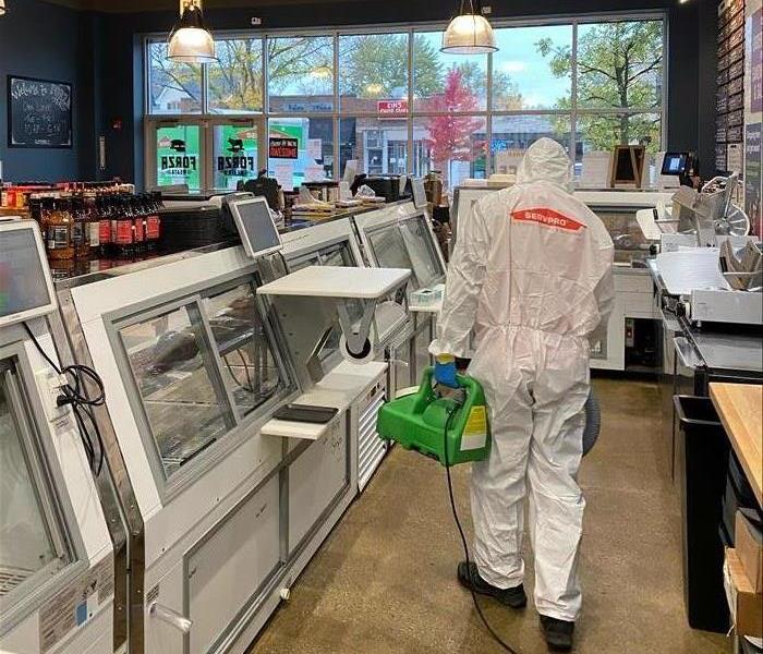 SERVPRO tech protected by full PPE cleans post-covid-exposure