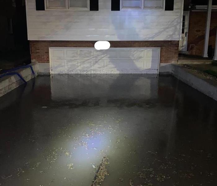 Photo showing a flooded driveway and garage